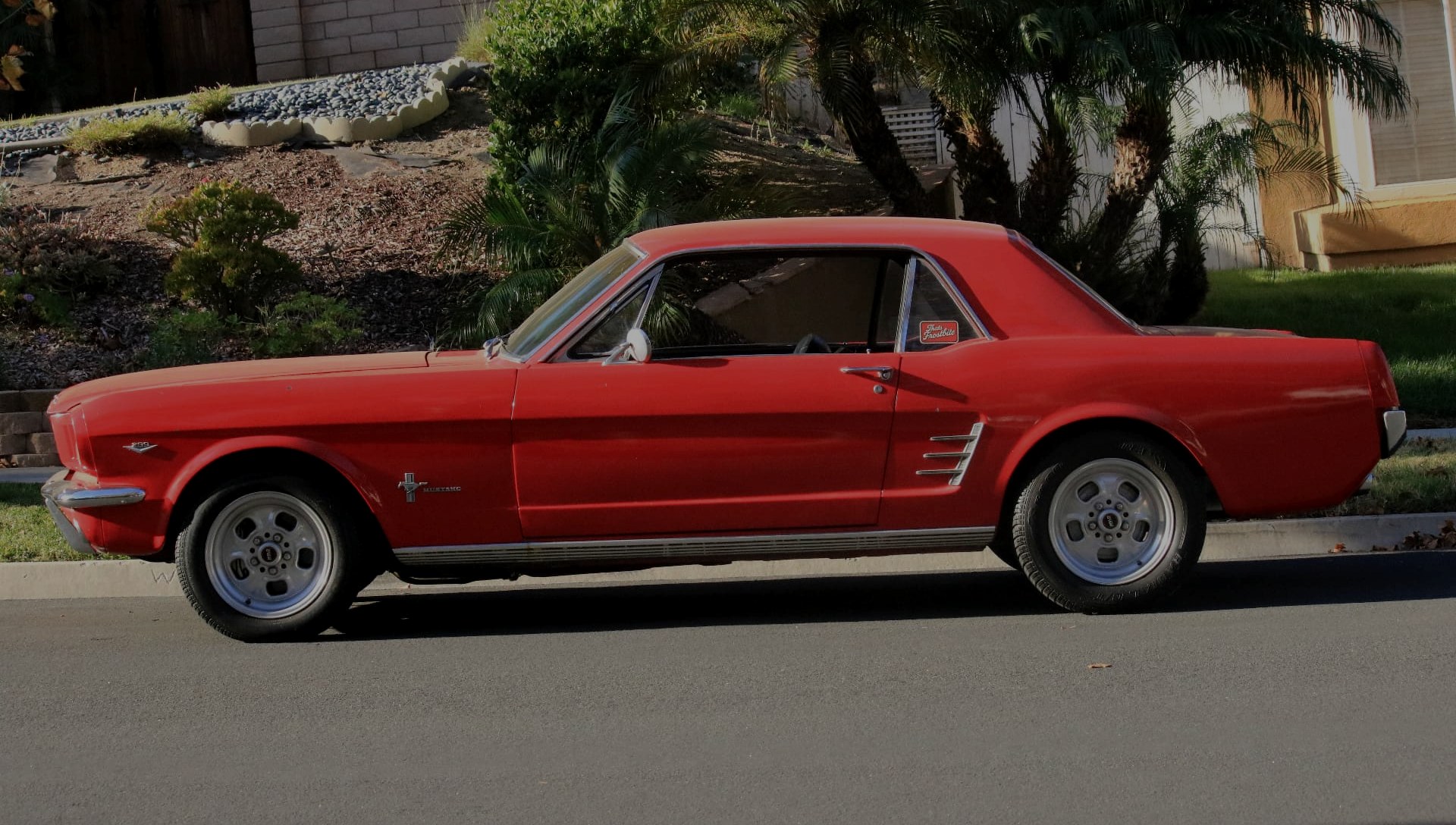 Red 1966 Ford Mustang coupe photographed in profile
